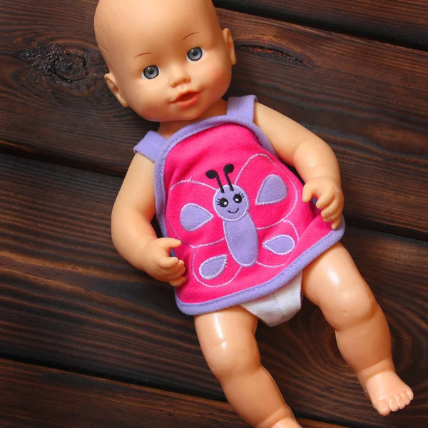 Baby doll on wooden background — Stock Photo, Image