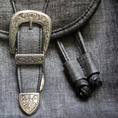 Kumaş arka plan. Toka yakın çekim.