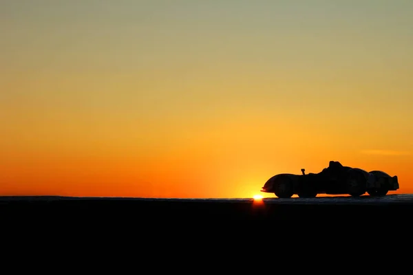 Car on a sunset background. Beautiful landscape. Car in the shade