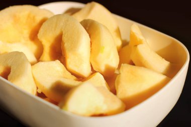 Siyah arka planda bir tabakta ayva. Cydonia oblonga