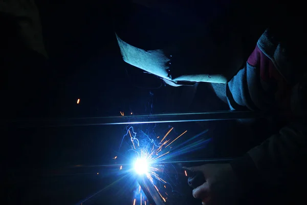 Sparks from welding. A man will weld metal. Workplace of the welder. Garage welder