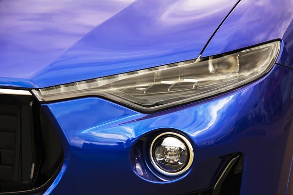 Car headlights. Luxury Headlights. Part of a blue car.