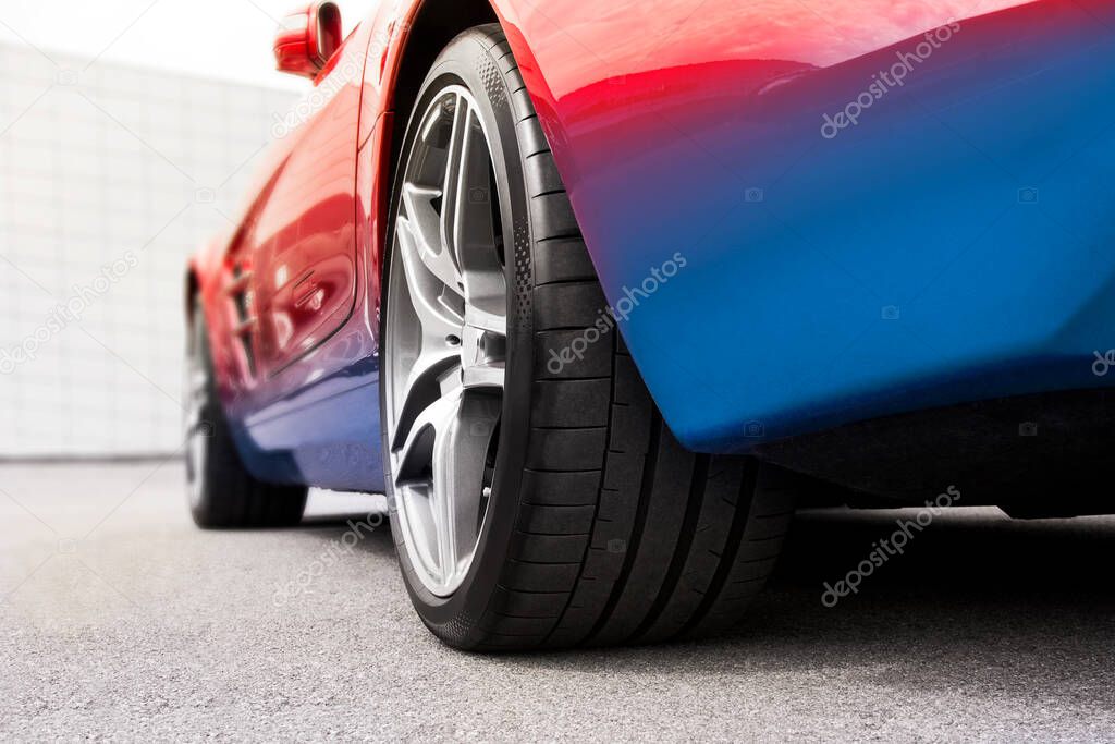 Car wheels on asphalt background. Car tires. Car wheels close up. Two-tone car. for advertising