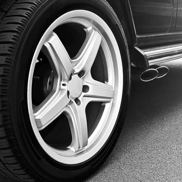 Car wheels close up on a background of asphalt. Car tires. Car wheel close-up. for advertising. Wallpaper