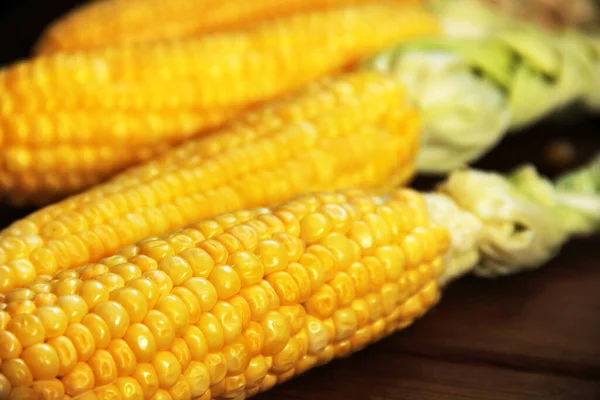 Corn. Yellow corn close up. Corn on wooden background