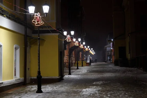 Bright light from a vintage lamp post in Christmas night