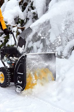 A snow thrower is the best assistant for snow removal in the winter clipart