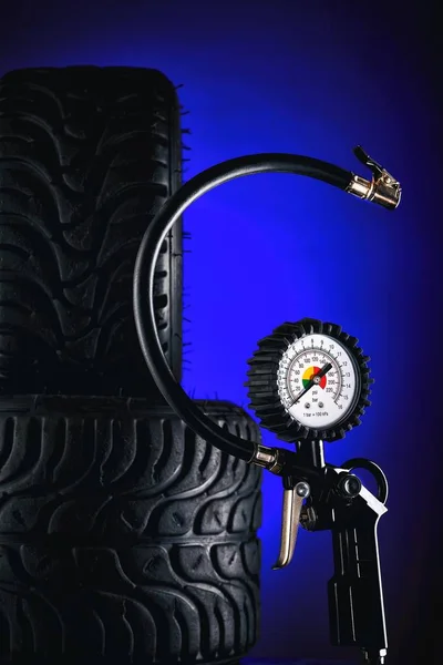 tire pressure gauge on dark background close-up