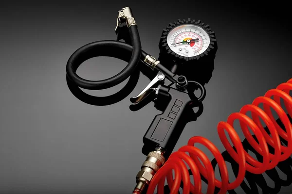 tire pressure gauge on dark background close-up