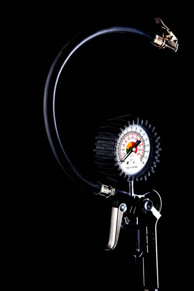 tire pressure gauge on dark background close-up