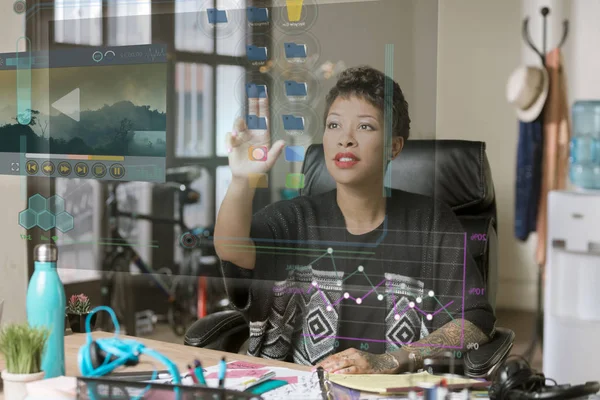 Professional woman working on a futuristic screen in her office