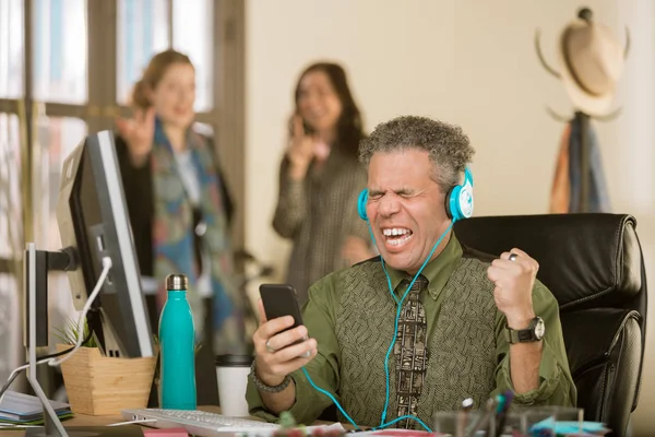 Professional man singing loudly enough to annoy colleagues