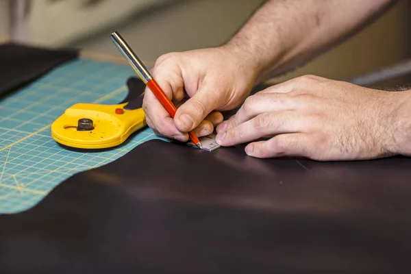 Marking a piece of leather for cutting with a rotary cutter
