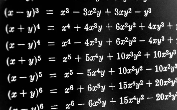 Large number of mathematical formulas on a black background