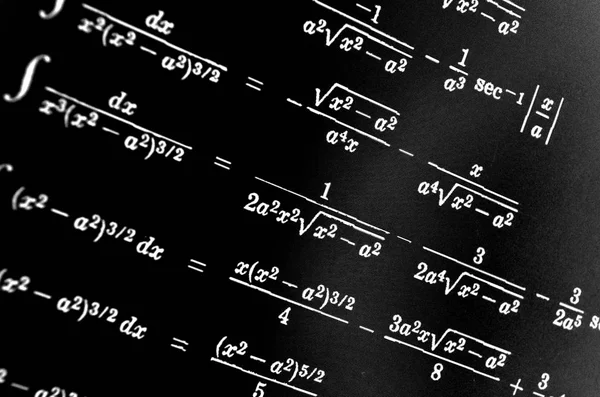 Large number of mathematical formulas on a black background