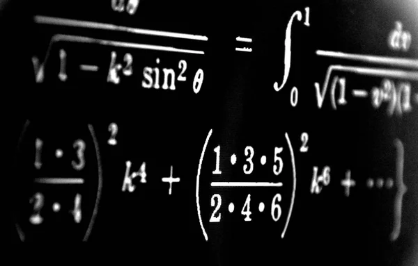Large number of mathematical formulas on a black background