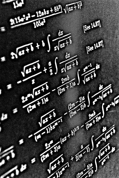 Large number of mathematical formulas on a black background HDR