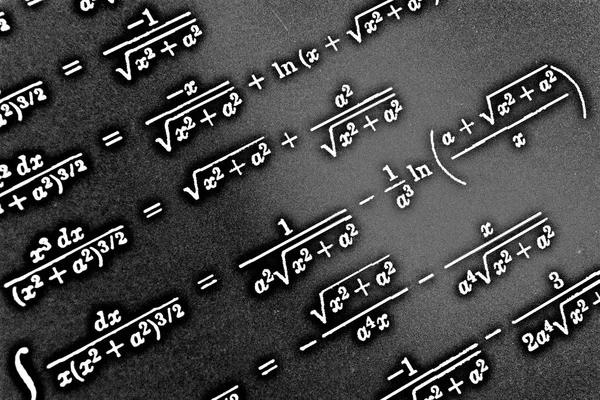 Large number of mathematical formulas on a black background HDR