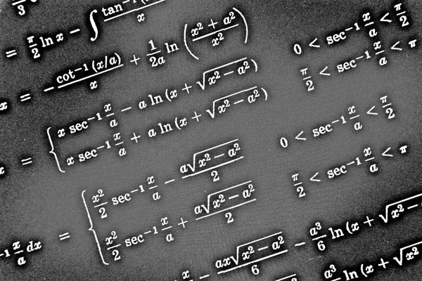 Large number of mathematical formulas on a black background HDR