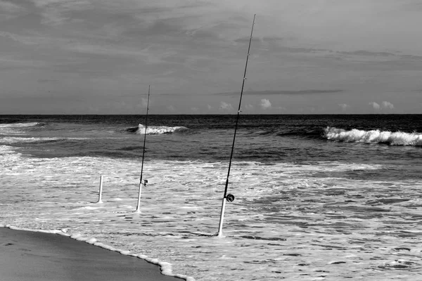 Surf fishing pole casted out to catch fish at the ocean surf Florida, USA