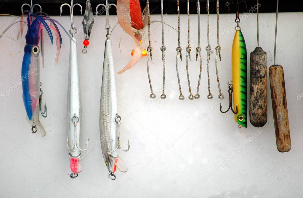 Array fishing lures hanging on chart boat background at Florida, USA