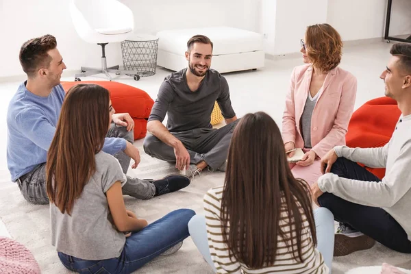 People at group psychotherapy session indoors