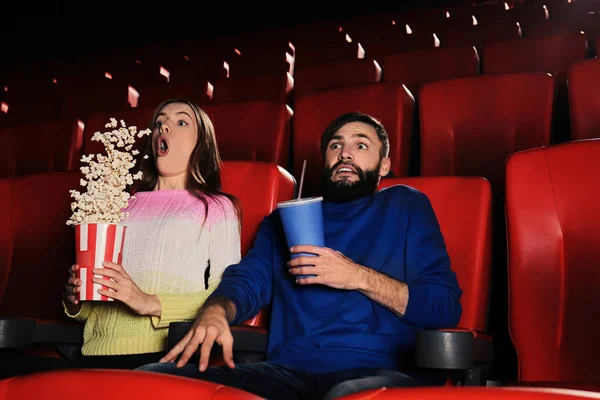 Emotional young couple watching movie in cinema — Stock Photo, Image