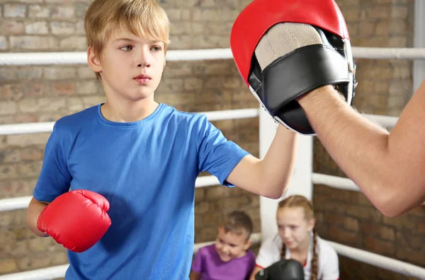 Niño pequeño con entrenador en el ring de boxeo —  Fotos de Stock