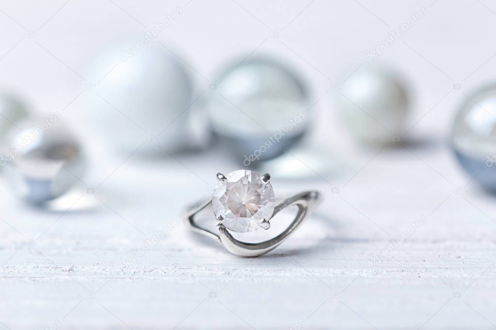 Beautiful engagement ring on light table, closeup