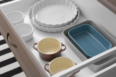 Set of kitchenware in drawer indoors clipart