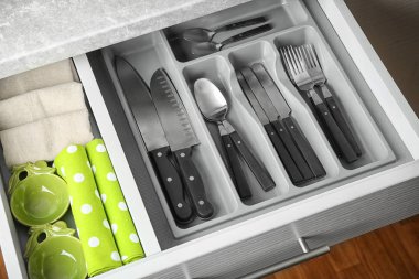 Set of cutlery in kitchen drawer clipart