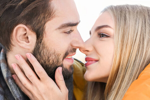 Portrait of young romantic couple outdoors, closeup