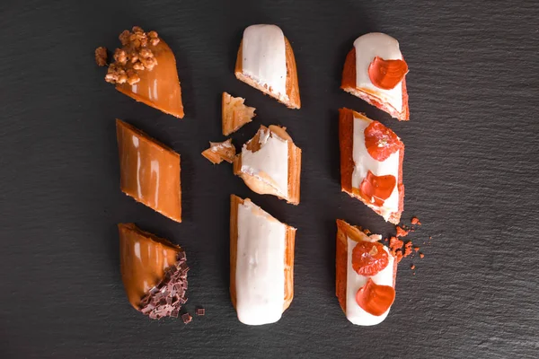 Tasty eklerleri siyah arka plan üzerine, yukarıdan kesti.