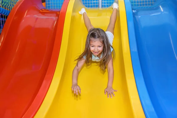 Little Girl Riding Slide Entertainment Center — Stock Photo, Image