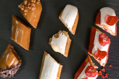 Tasty eklerleri siyah arka plan üzerine, yukarıdan kesti.