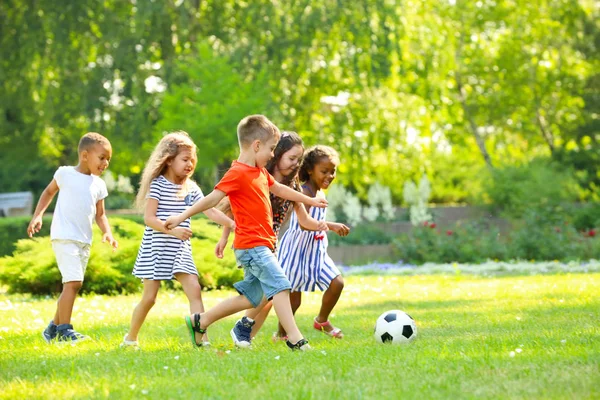 Cute Little Children Playing Football Outdoors Stock Image