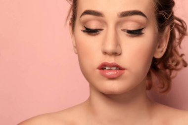 Renkli arka planda güzel kaşları olan genç bir kadın, yakın plan.