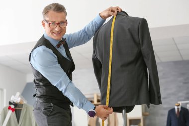 Atelier manken üzerinde ceket ölçümleri alarak terzi