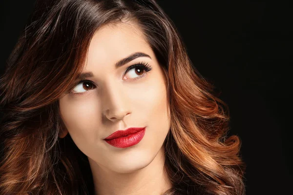 Zarif makyaj ve siyah arka plan üzerine uzun kirpiklerini çekici genç kadın. Kirpik uzantıları