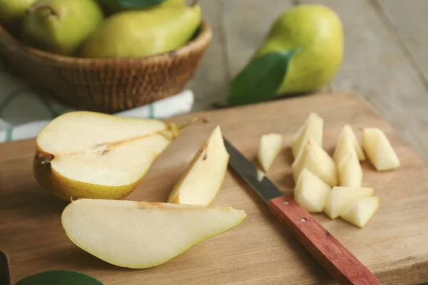 Cut pears on wooden board