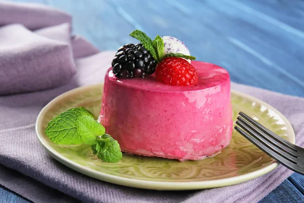 Tasty berry mousse cake on plate