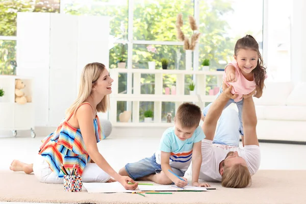 Happy couple spending time with children at home — Stock Photo, Image