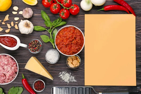 Composición de carne cruda con verduras y papel sobre fondo de madera — Foto de Stock