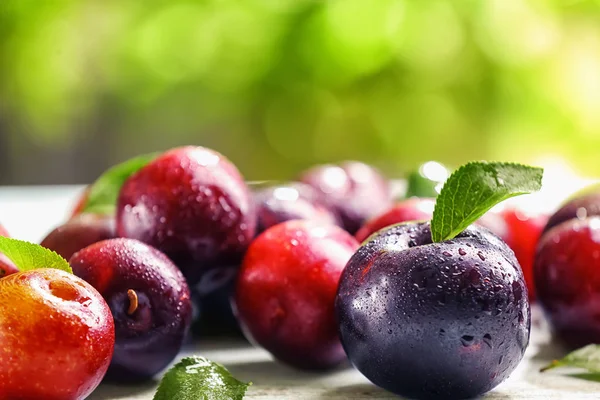 Ripe juicy plums on table — Stock Photo, Image