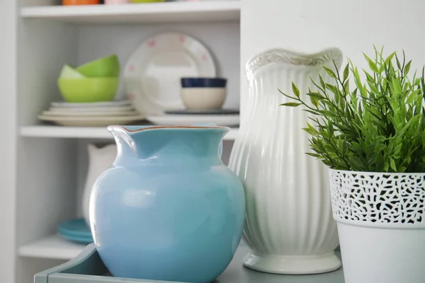 Two ceramic pitchers on shelf indoors — Stock Photo, Image