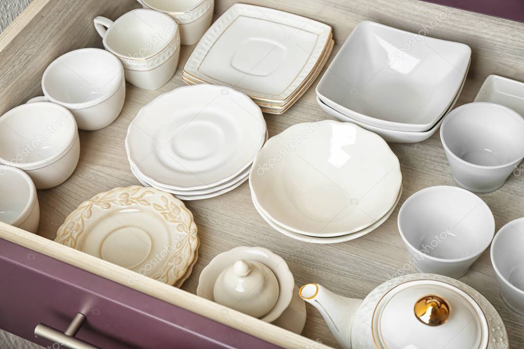 Ceramic dishware in kitchen drawer