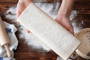 Masa üzerinde üstten görünüm ham lapa lapa hamur tutan kadın