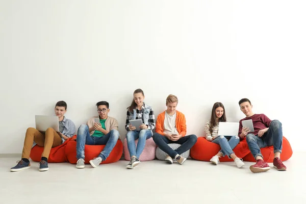 Group of teenagers with modern devices