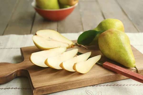 Cut pears on wooden board