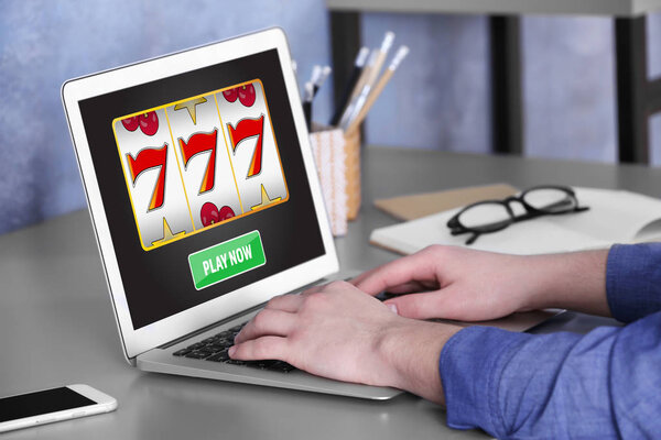 Man using laptop for playing online casino game at home